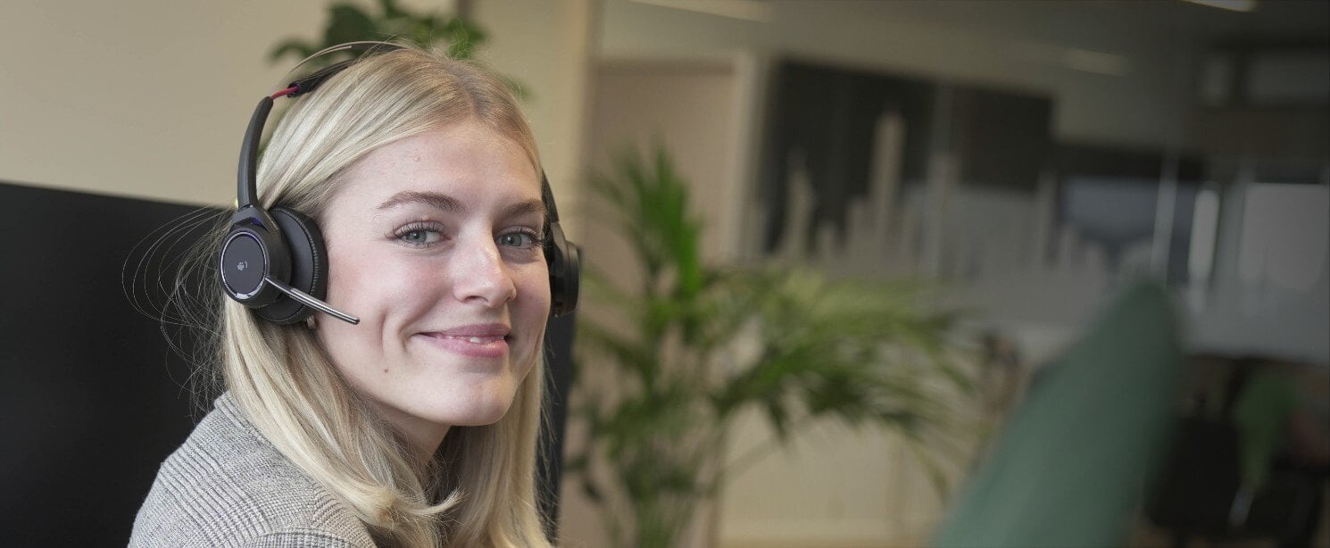 Woman wearing a headset, smiling at the camera